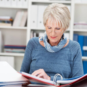 older woman studying business report